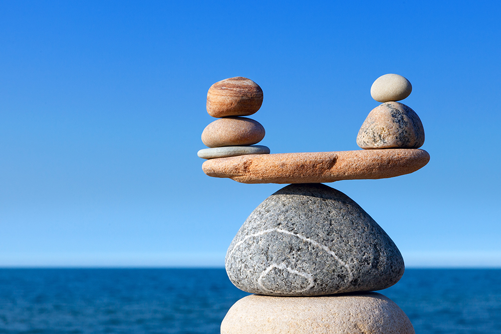 Concept of harmony and balance. Balance stones against the sea. Rock zen in the form of scales